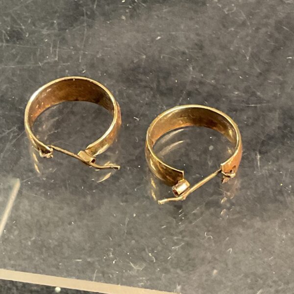 Delicate 9ct gold hoop earrings, classic jewellery design.