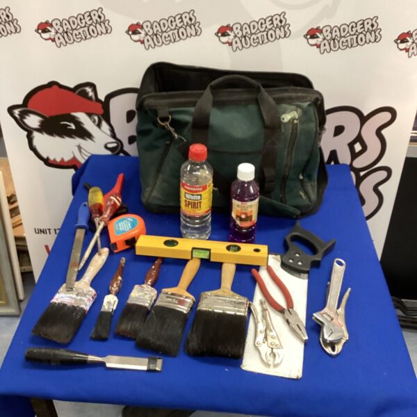 Tool bag with paint brushes and hand tools for DIY projects.