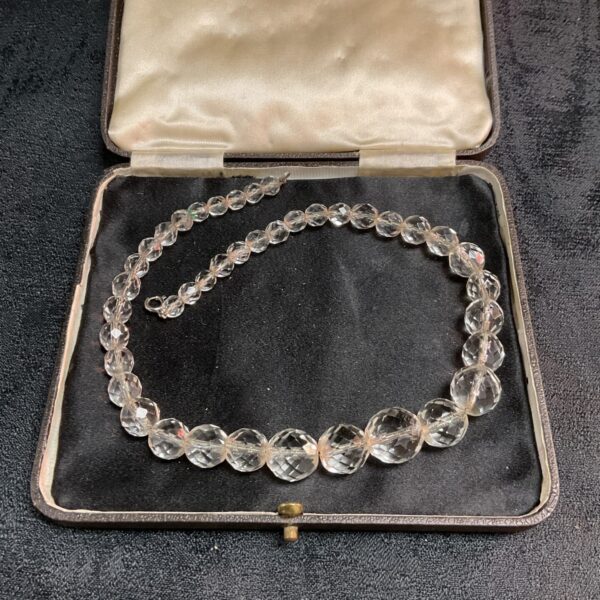 Antique rock crystal necklace displayed in its original presentation box.