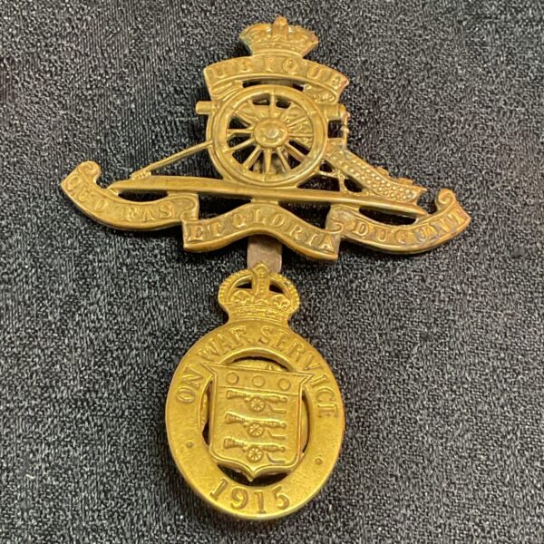 Brass Royal Artillery cap badge from 1915, a WWI collectible.
