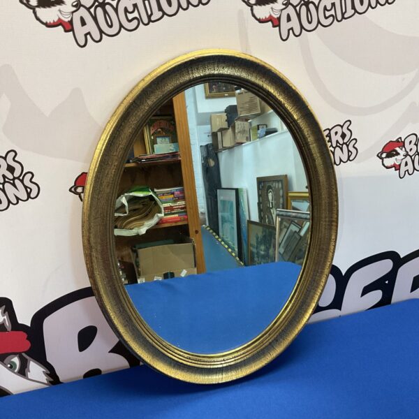 Gilt framed oval mirror