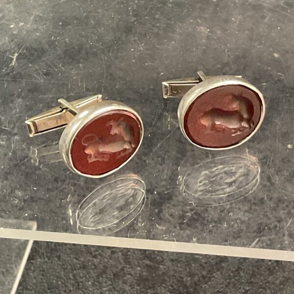 Antique silver cufflinks with carved carnelian wax seal detail.