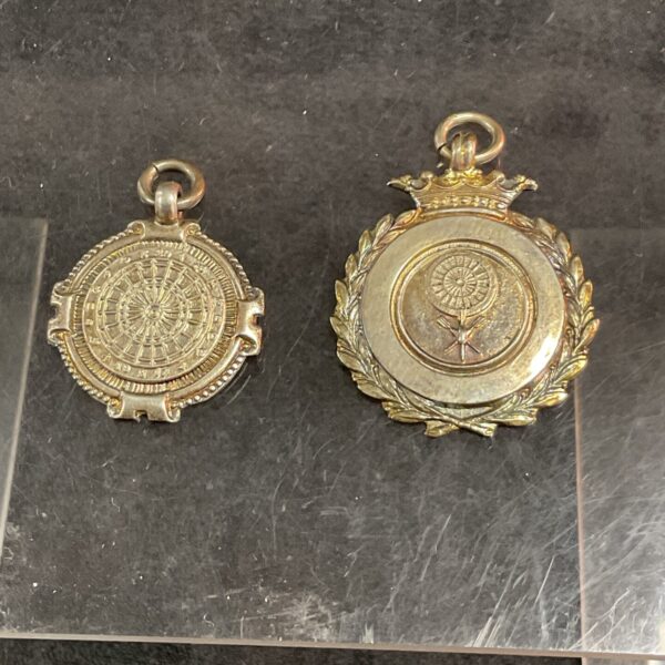 Vintage silver darts medal with radial design and hallmarked silver.