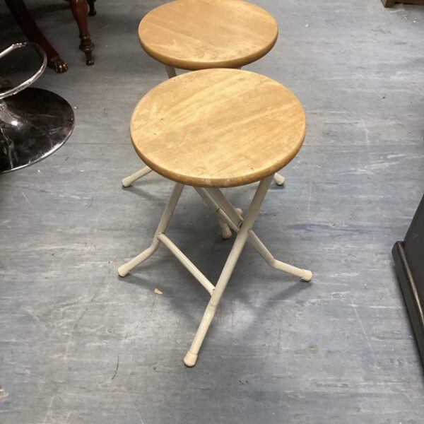 Pair of vintage folding stools with wooden seats.