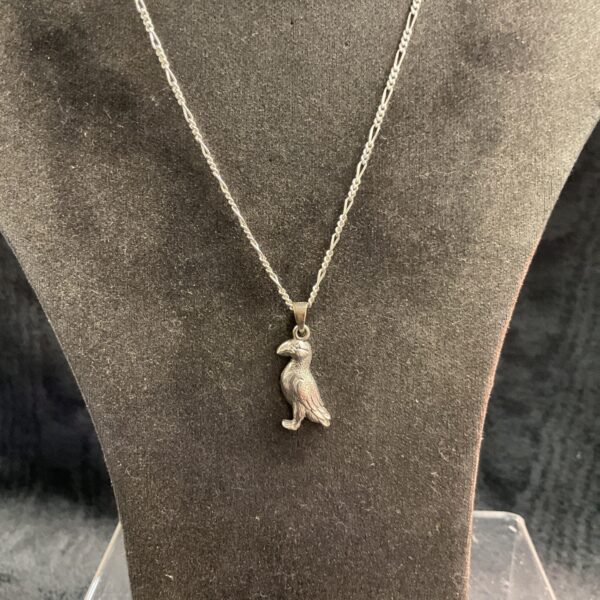 Detailed silver puffin necklace with a delicate chain.