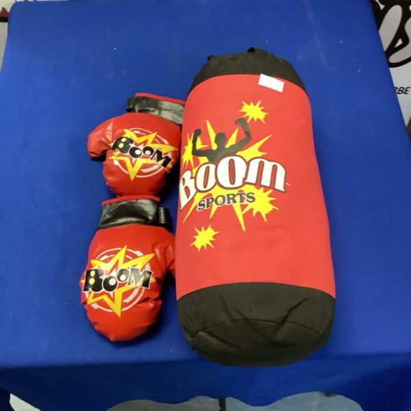 Red kids boxing gloves and punch bag set for training.