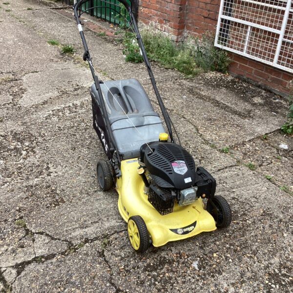Texas Power Line petrol lawn mower in a garden setting.