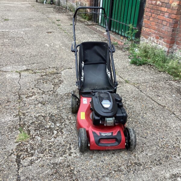 Used Mountfield Stiga petrol lawn mower in a garden setting.