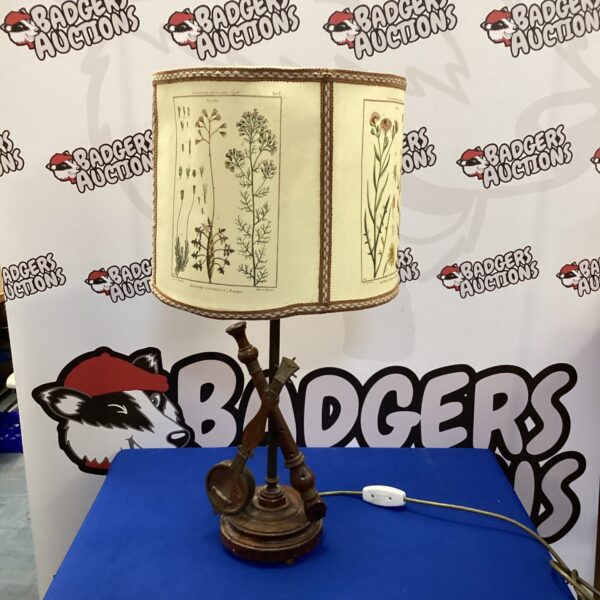 Vintage banjo and flute table lamp with musical instrument details.