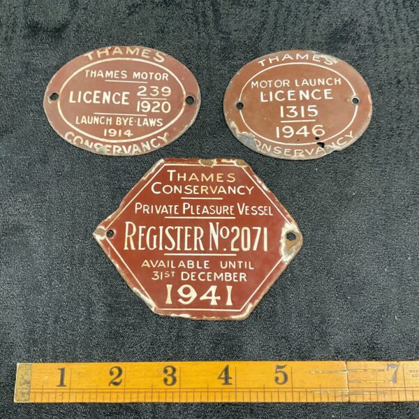 Vintage Thames Conservancy enamel registration plates from 1914, 1941, and 1946.