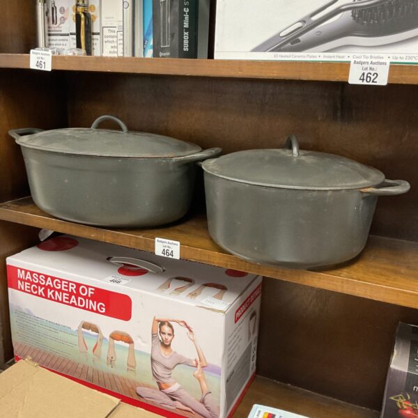 Vintage Belgium cast iron pots with enamel coating for cooking.