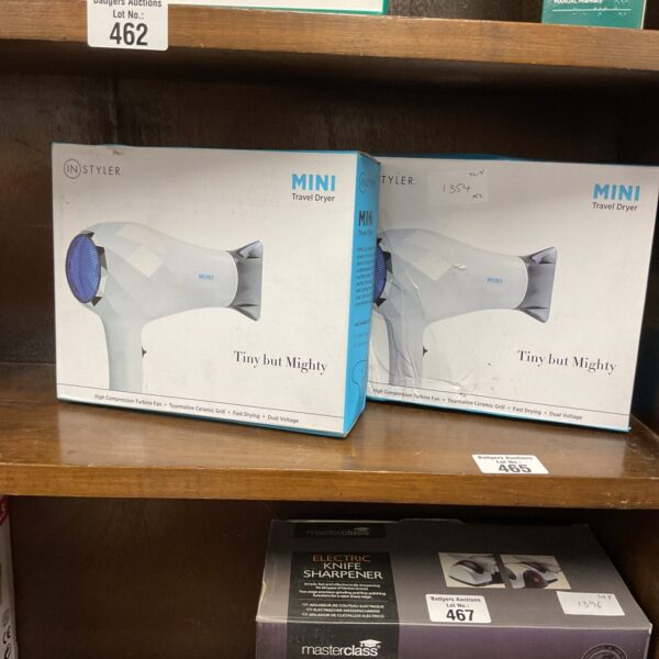 Two Instyle mini travel dryers presented in packaging.