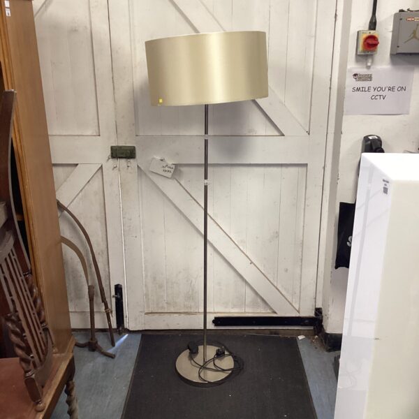Chrome standard lamp with cream shade, vintage floor lighting.