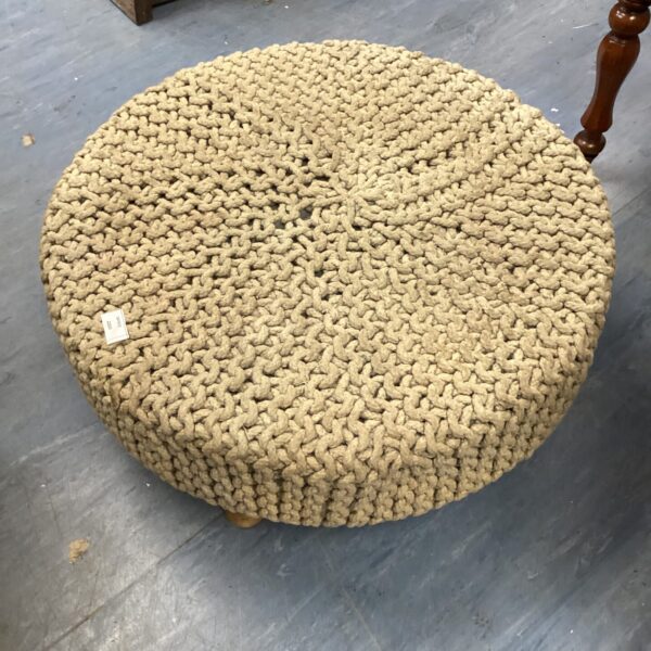 Large round jute footstool for comfortable home seating.