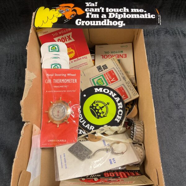 Box of vintage motoring stickers and ephemera, including oil and tyre brands.