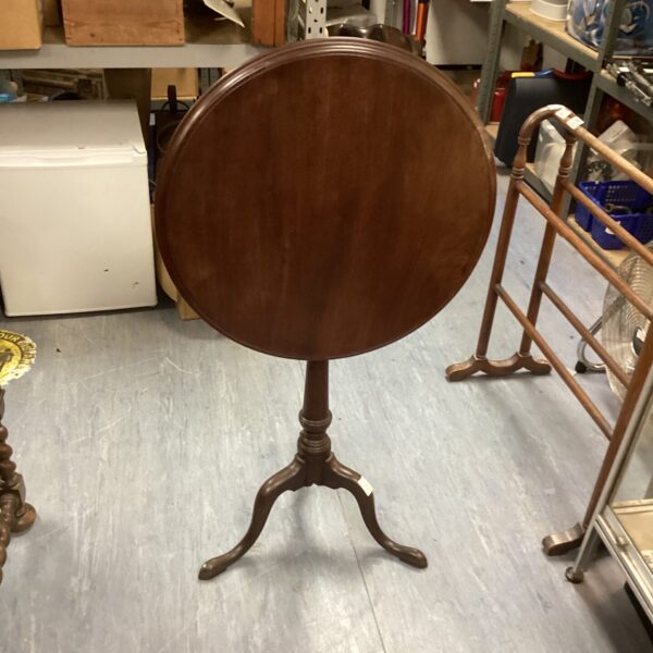 Vintage mahogany occasional table with tripod legs.