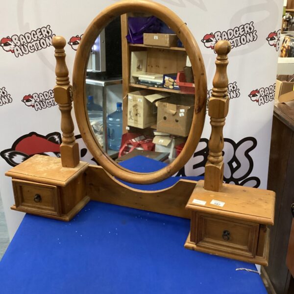 Vintage pine dressing table mirror with drawers for bedroom storage.