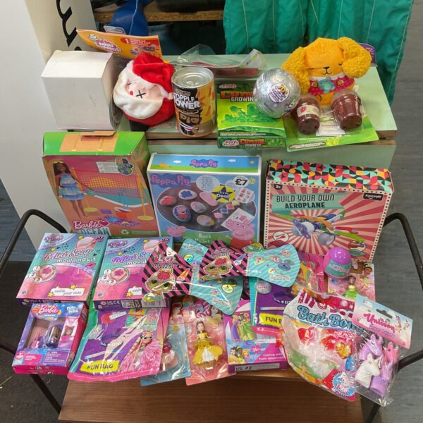 Colourful toy bundle with LOL Surprise, Barbie, and Peppa Pig toys.