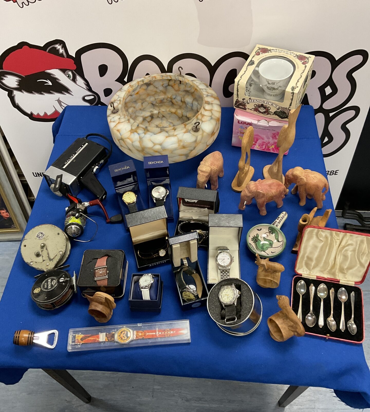 Mixed lot to include Accurist and Seconda watches 1930s glass shade fishing reels and wood elephants