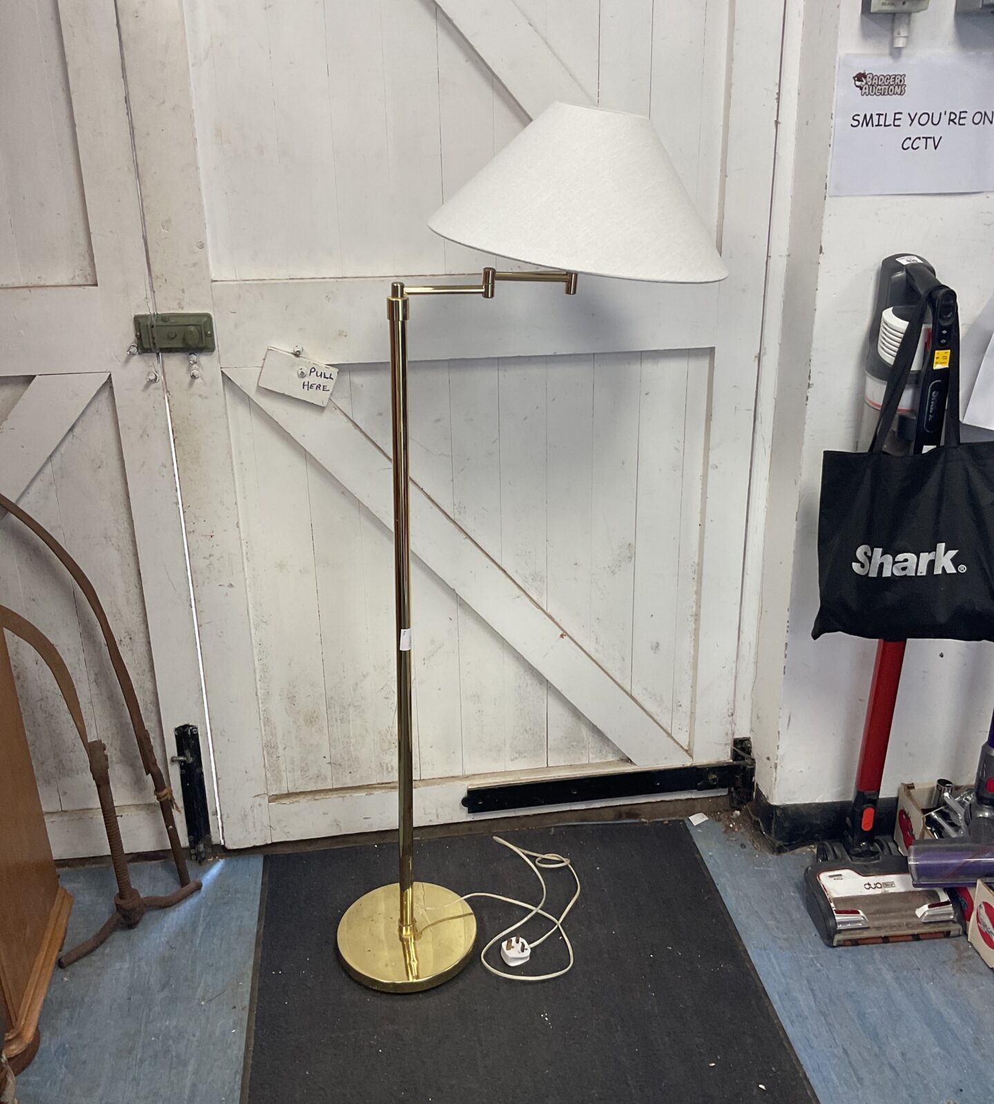 Brass floor standing lamp with cream shade