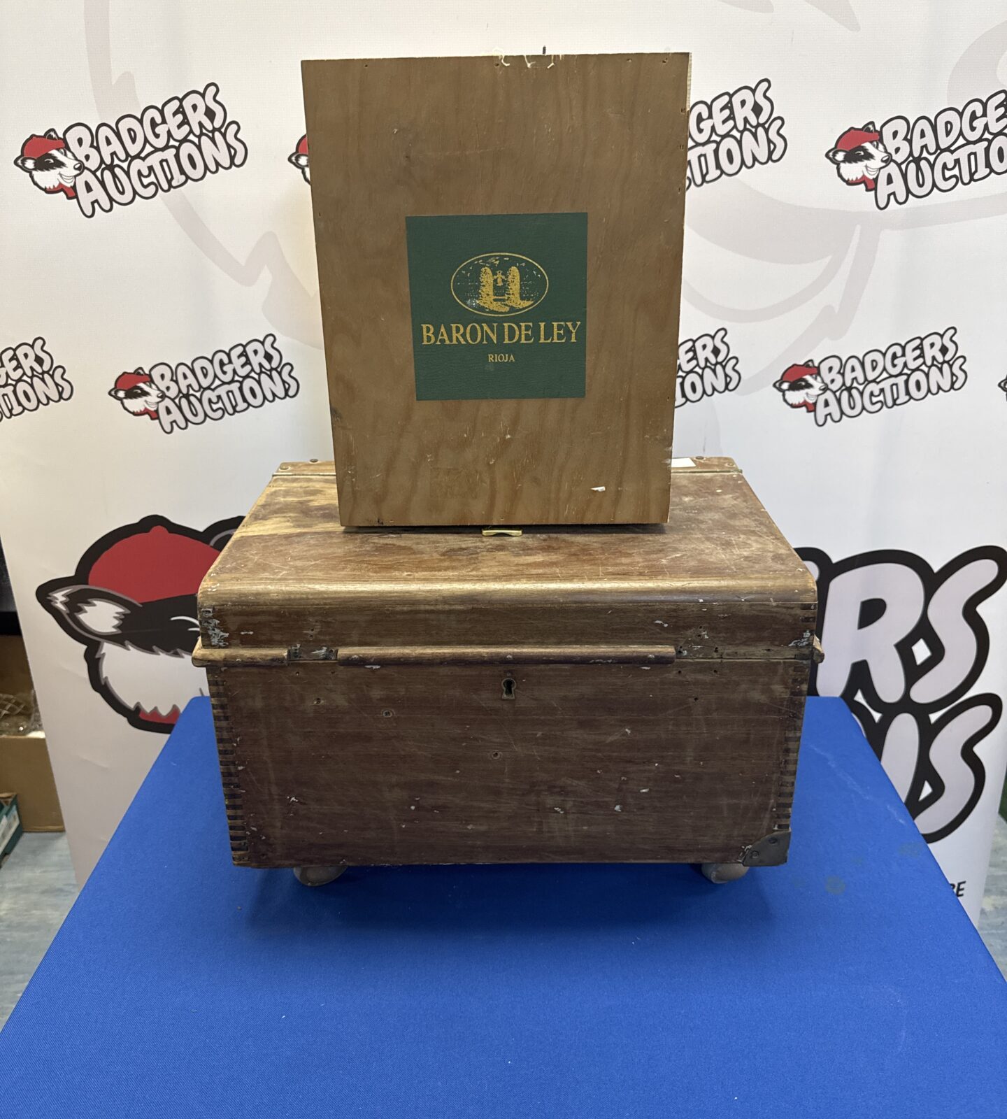 Vintage wooden chest on castor wheels (key present inside) with baron de ley wine case