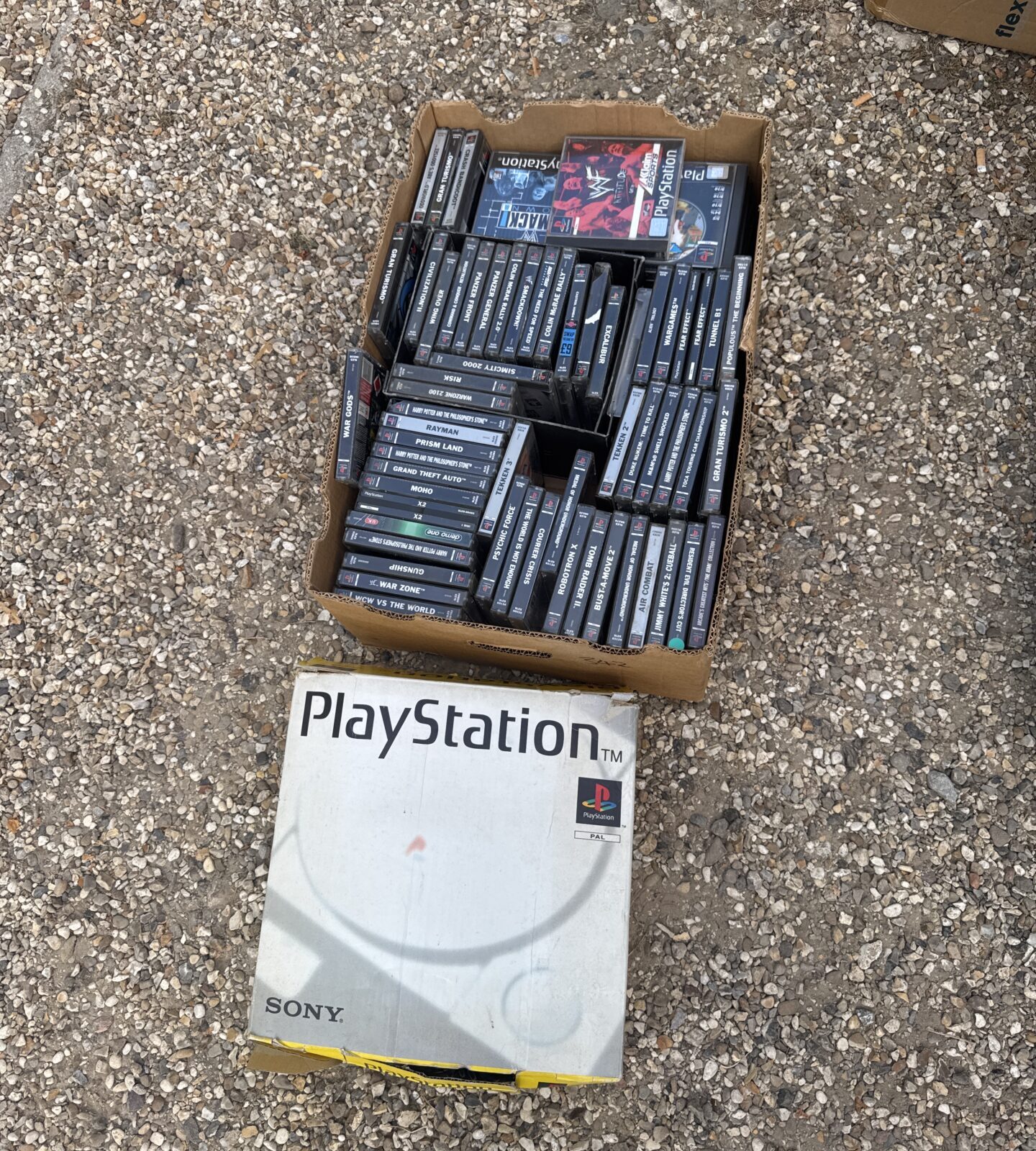 Sony PlayStation console boxed with tray of games