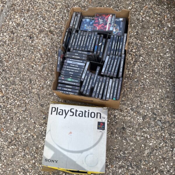 Sony PlayStation console boxed with tray of games
