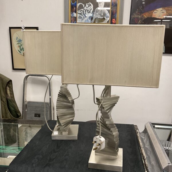 Pair of modern table lamps with sculptural bases and white shades.