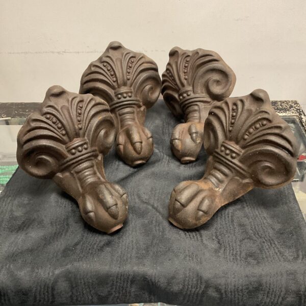 Ornate Victorian bath feet with ball and claw design.