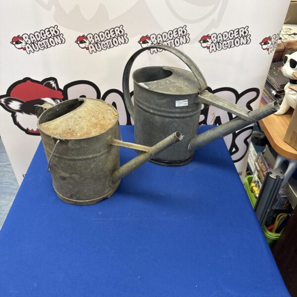 Two vintage galvanised watering cans