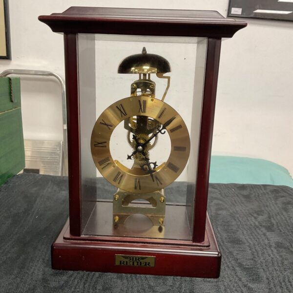 Vintage skeleton mantle clock with visible gears and Roman numerals.
