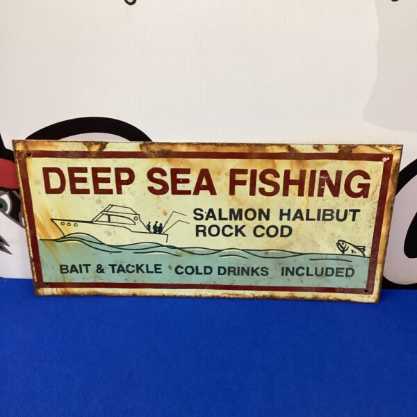 Vintage deep sea fishing tin sign with colourful graphics.