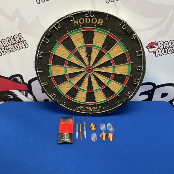 Vintage Nodor dartboard with darts, a classic pub game.