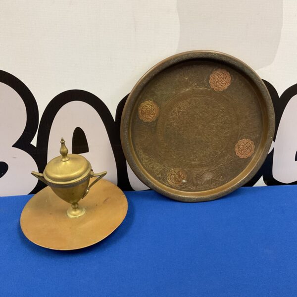 Vintage copper plate and brass inkwell set on a white surface.