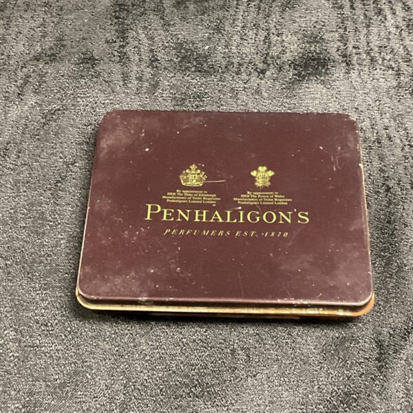 Vintage Penhaligon's perfume tin with royal warrants displayed on the front.