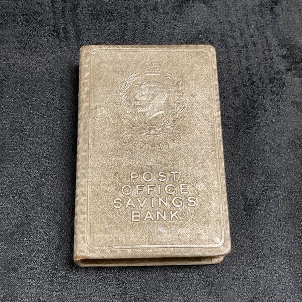 Vintage George V Post Office Savings Bank with coins.