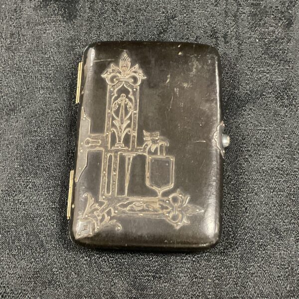 Antique Art Nouveau silver card case with detailed silver overlay.
