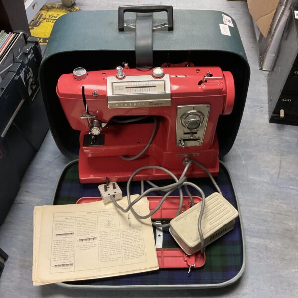 Vintage pink Brother Deluxe sewing machine with case.