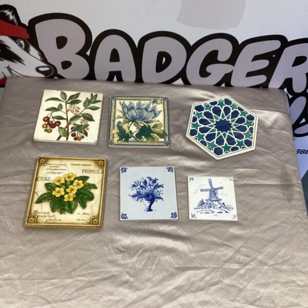 Vintage Delft wall tiles with blue and white windmill design.