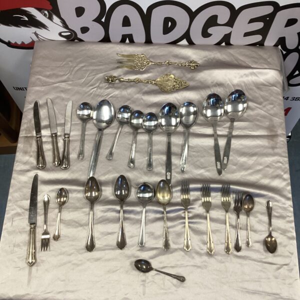 Vintage silverplate cutlery set displayed on a white surface.