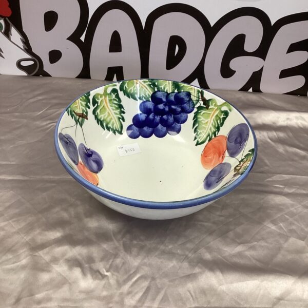Vibrant ceramic fruit bowl with detailed grape design.