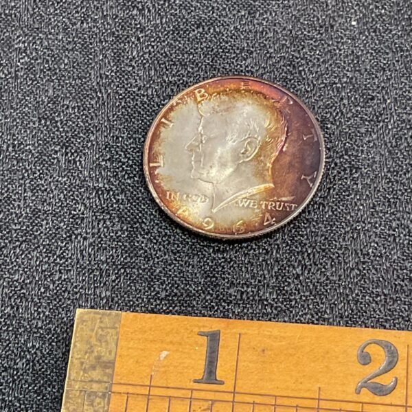 Close-up of the obverse of a 1964 Kennedy silver half dollar coin.
