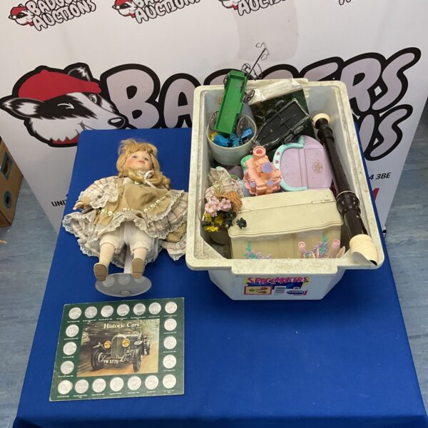 Vintage doll and collectibles lot including Polly Pocket and historic cars.