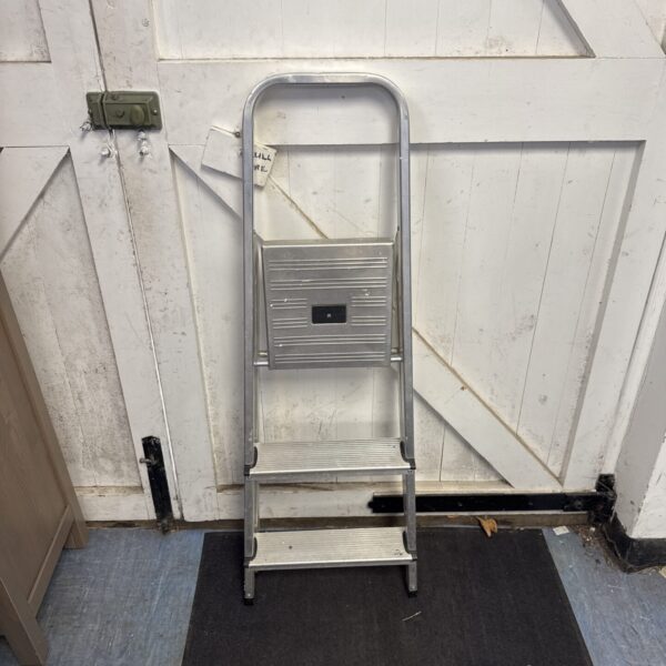 Vintage metal folding step ladder with three steps.