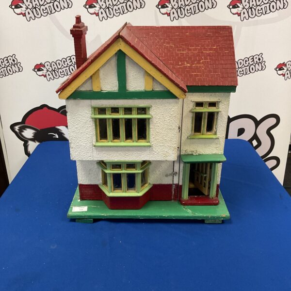 Vintage wooden model house with opening front wall for display.