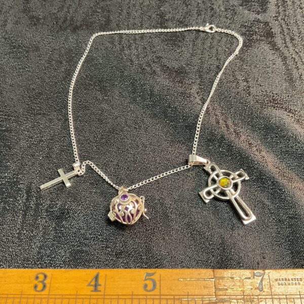 A religious shatlelain  with crucifix and silver case amethyst ball pendant
