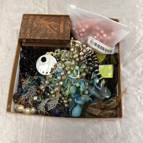 Angled view of a costume jewellery lot with a wooden box.