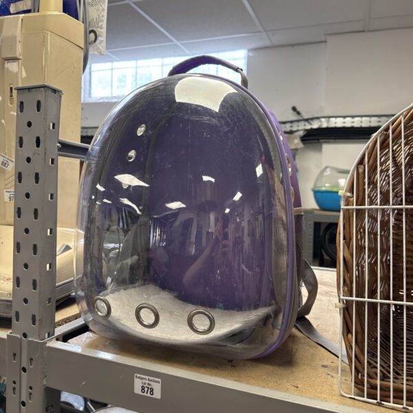 Transparent pet carrier backpack for small cats and dogs.