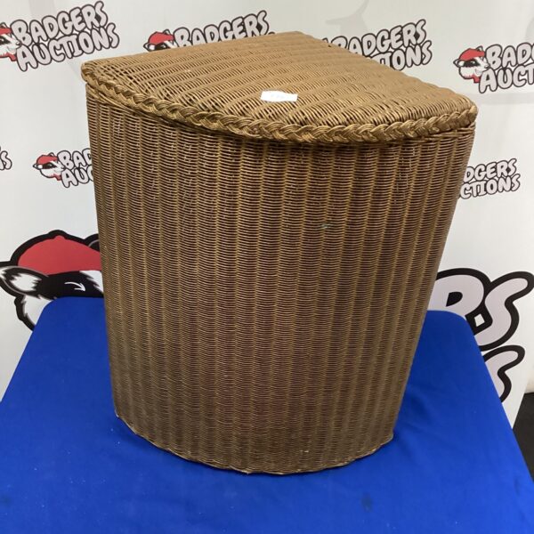 Vintage Lloyd Loom laundry basket for corner storage.