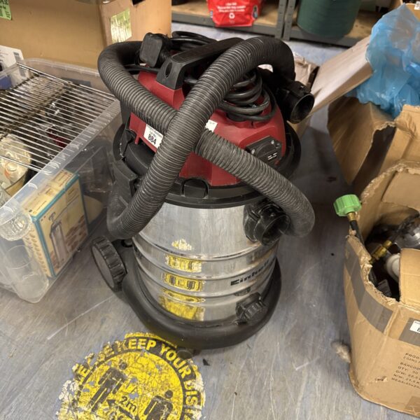 Red Einhell wet & dry vacuum cleaner with flexible hose.